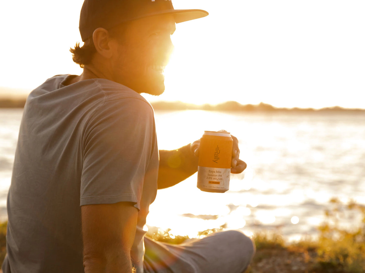 Rally Extra Mile in hand at beach during sunset