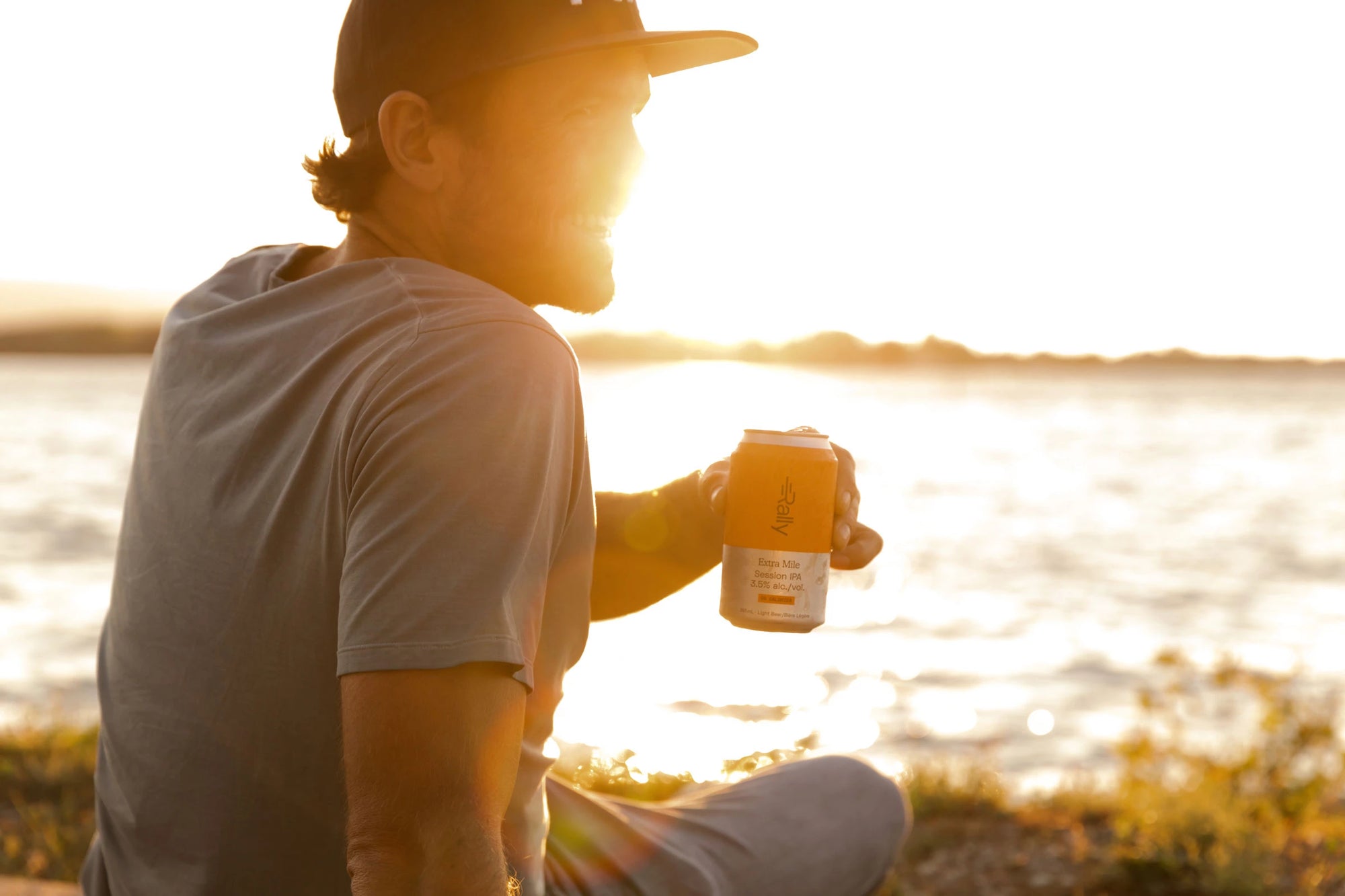 Rally Extra Mile in hand at beach during sunset